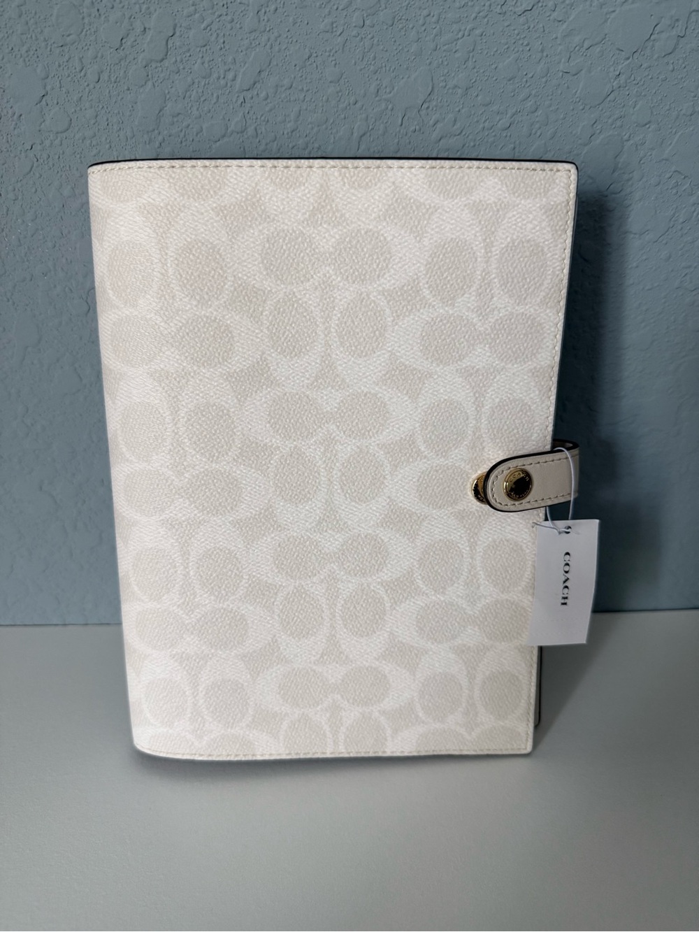 Brand new white coach notebook.